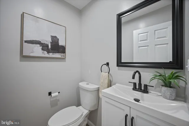 a bathroom with a toilet a sink and mirror