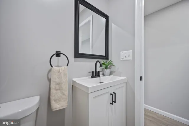a bathroom with a sink a toilet and mirror