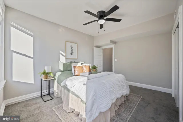 a bedroom with a bed a table and chair