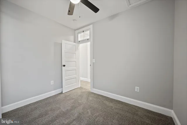 an empty room with closet and wooden floor