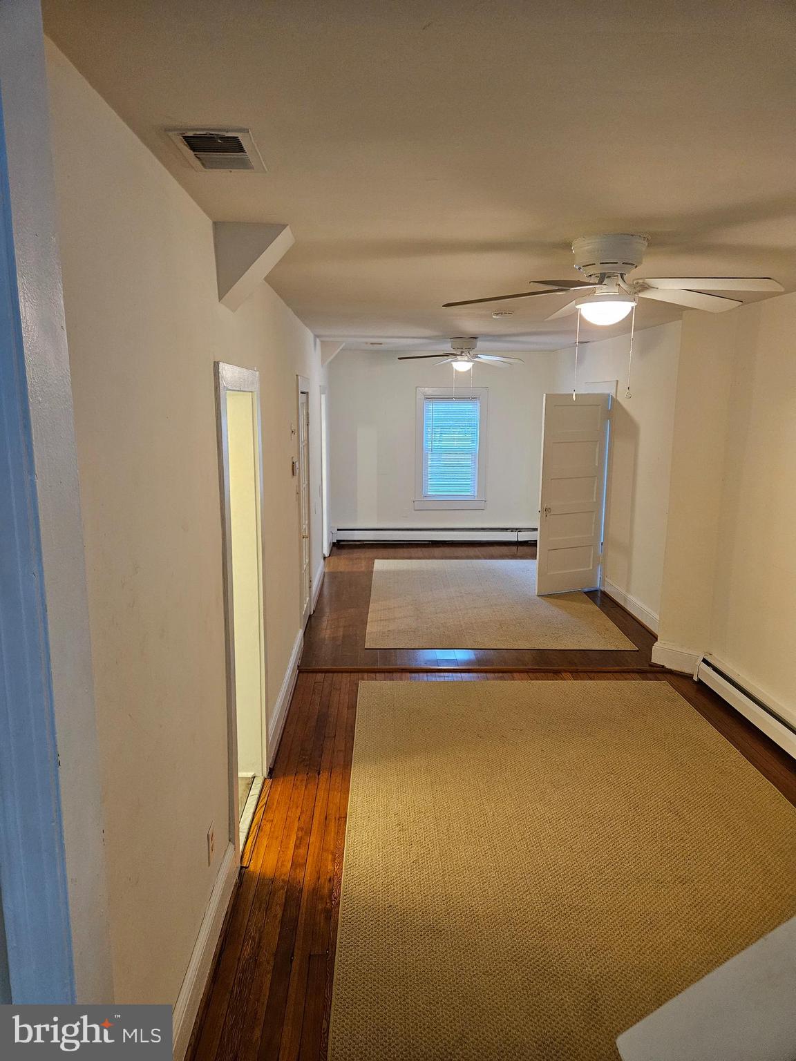 7204 Webster Lane Fort Washington, MD 20744 - Photo 4 of 27 a view of a livingroom with wooden floor and a ceiling fan
