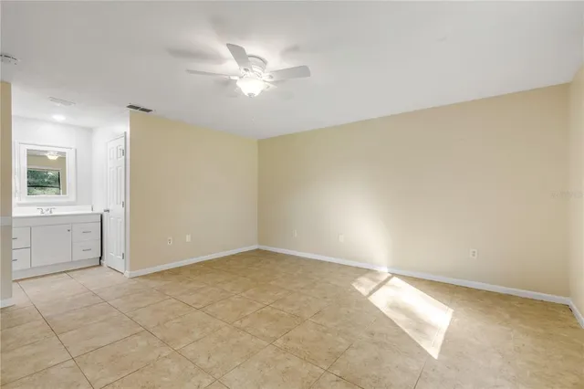 an empty room with a bathroom and a sink