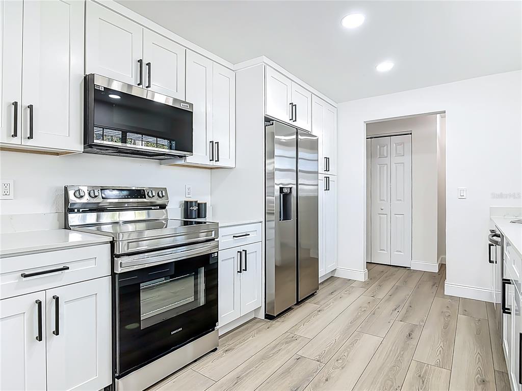 612 Devon Street Port Orange, FL 32127 - Photo 13 of 34 a kitchen with stainless steel appliances a stove a refrigerator and a microwave