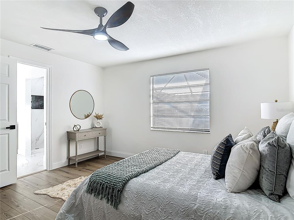 612 Devon Street Port Orange, FL 32127 - Photo 17 of 34 a bedroom with bed and window