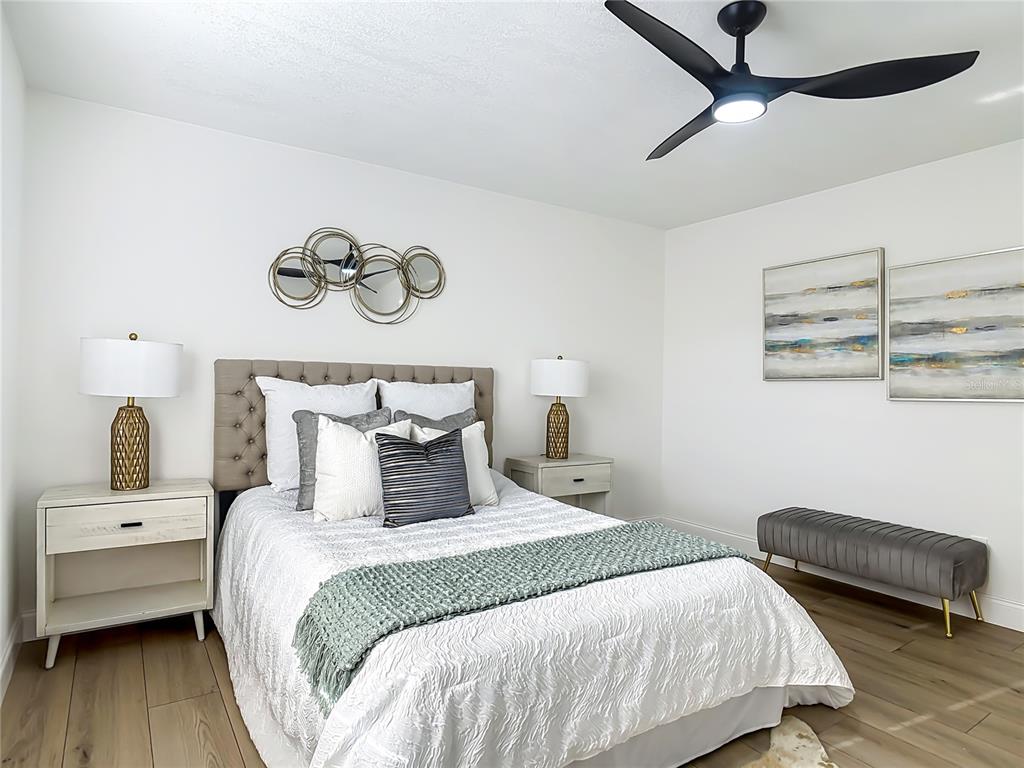 612 Devon Street Port Orange, FL 32127 - Photo 18 of 34 a bedroom with a bed and a chair