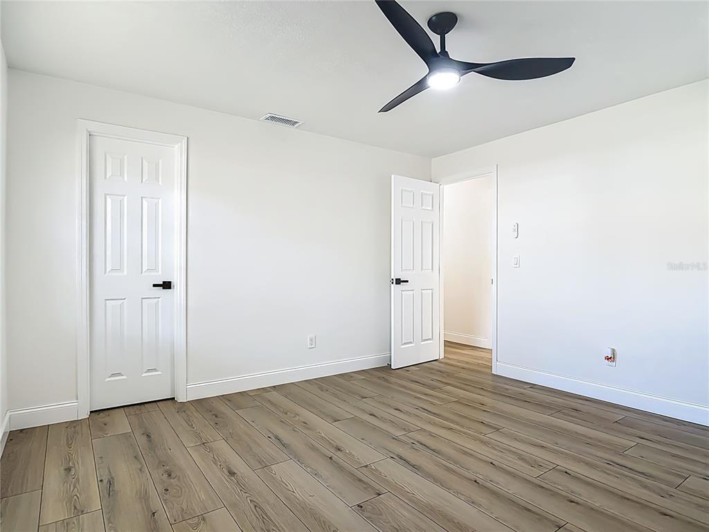 612 Devon Street Port Orange, FL 32127 - Photo 22 of 34 wooden floor in an empty room