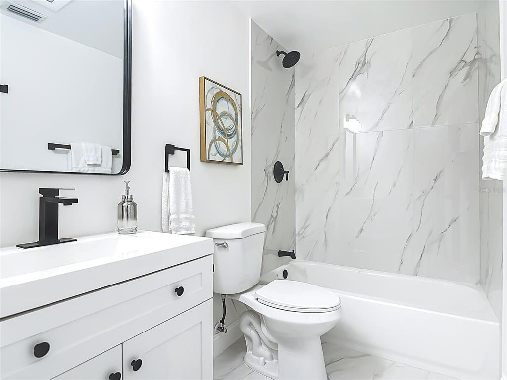 612 Devon Street Port Orange, FL 32127 - Photo 23 of 34 a bathroom with a sink a toilet and a bathtub