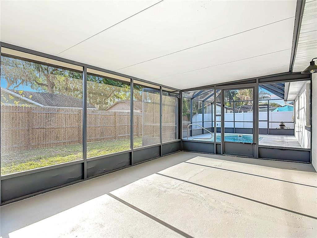 612 Devon Street Port Orange, FL 32127 - Photo 25 of 34 a view of an empty room with wooden floor and a window