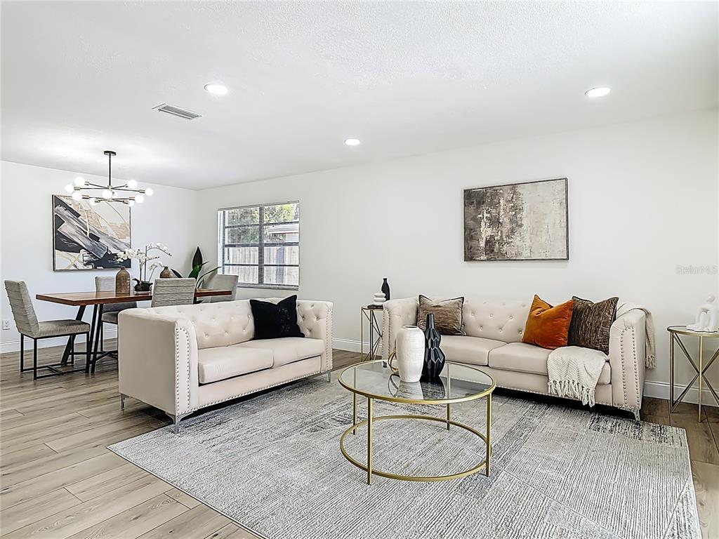 612 Devon Street Port Orange, FL 32127 - Photo 6 of 34 a living room with furniture a rug and white walls