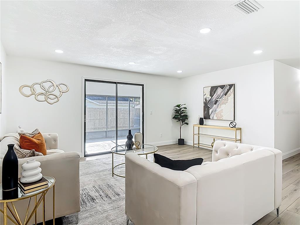 612 Devon Street Port Orange, FL 32127 - Photo 9 of 34 a living room with furniture and a potted plant