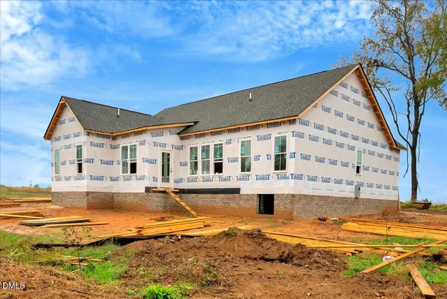 a view of a house with swimming pool and sitting area