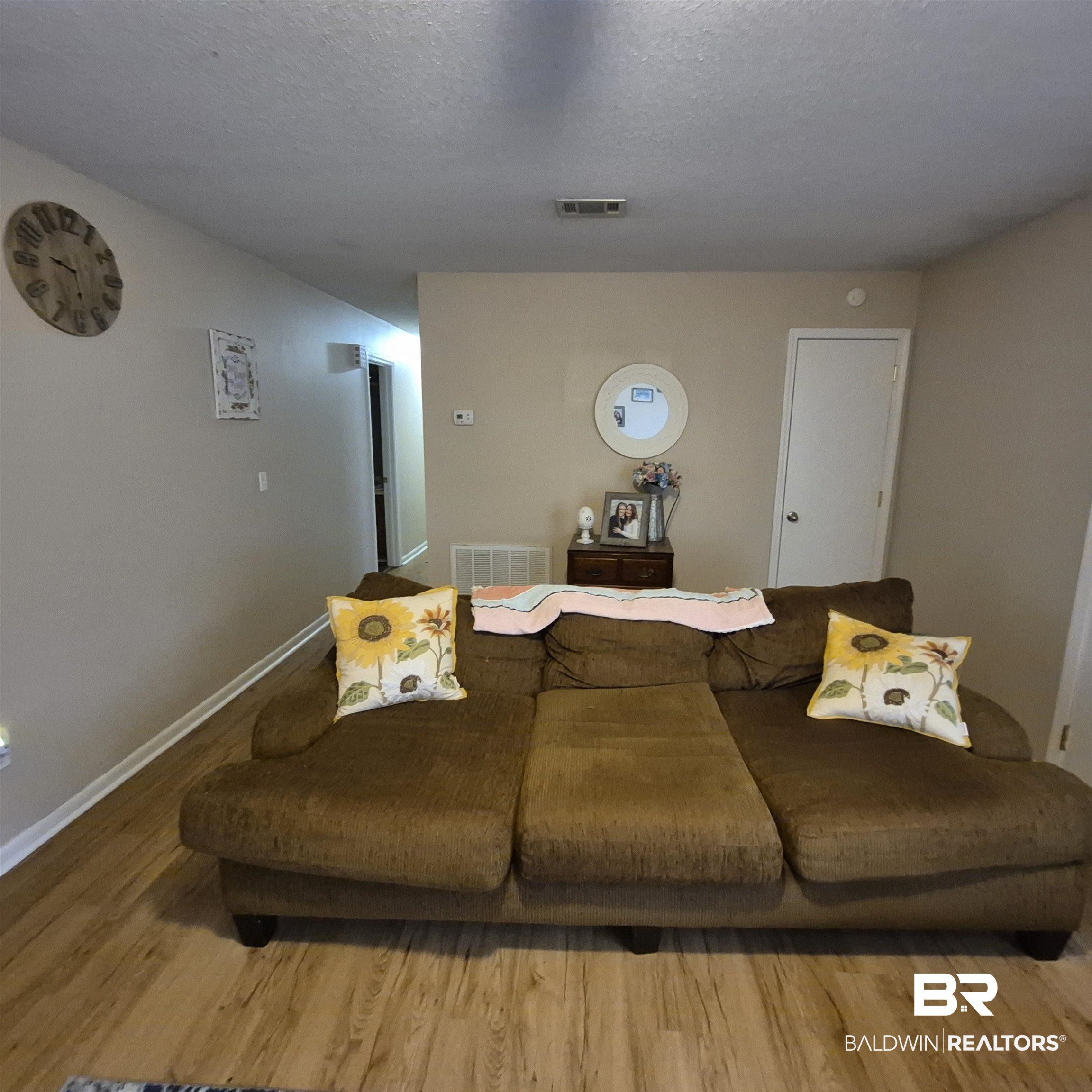 721 Perryman Street Evergreen, AL 36401 - Photo 6 of 26 Living room featuring wood finished floors and a textured ceiling