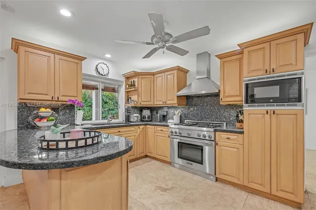 a kitchen with stainless steel appliances granite countertop a stove and a microwave
