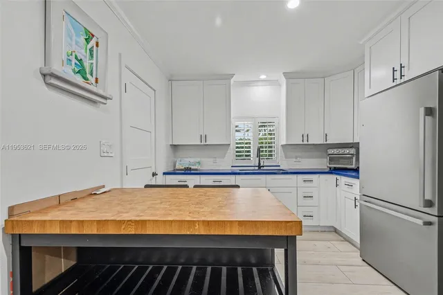 a kitchen with stainless steel appliances granite countertop a stove a sink and a refrigerator