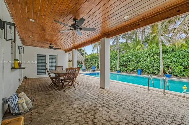 a view of a patio with table and chairs and wooden floor