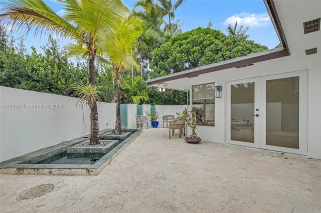 a view of a wooden door and bench in front of a house