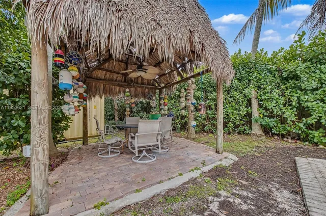 a view of a chairs and table in the backyard