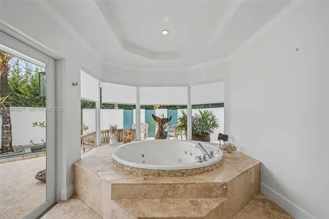 a view of bathroom with a tub and windows