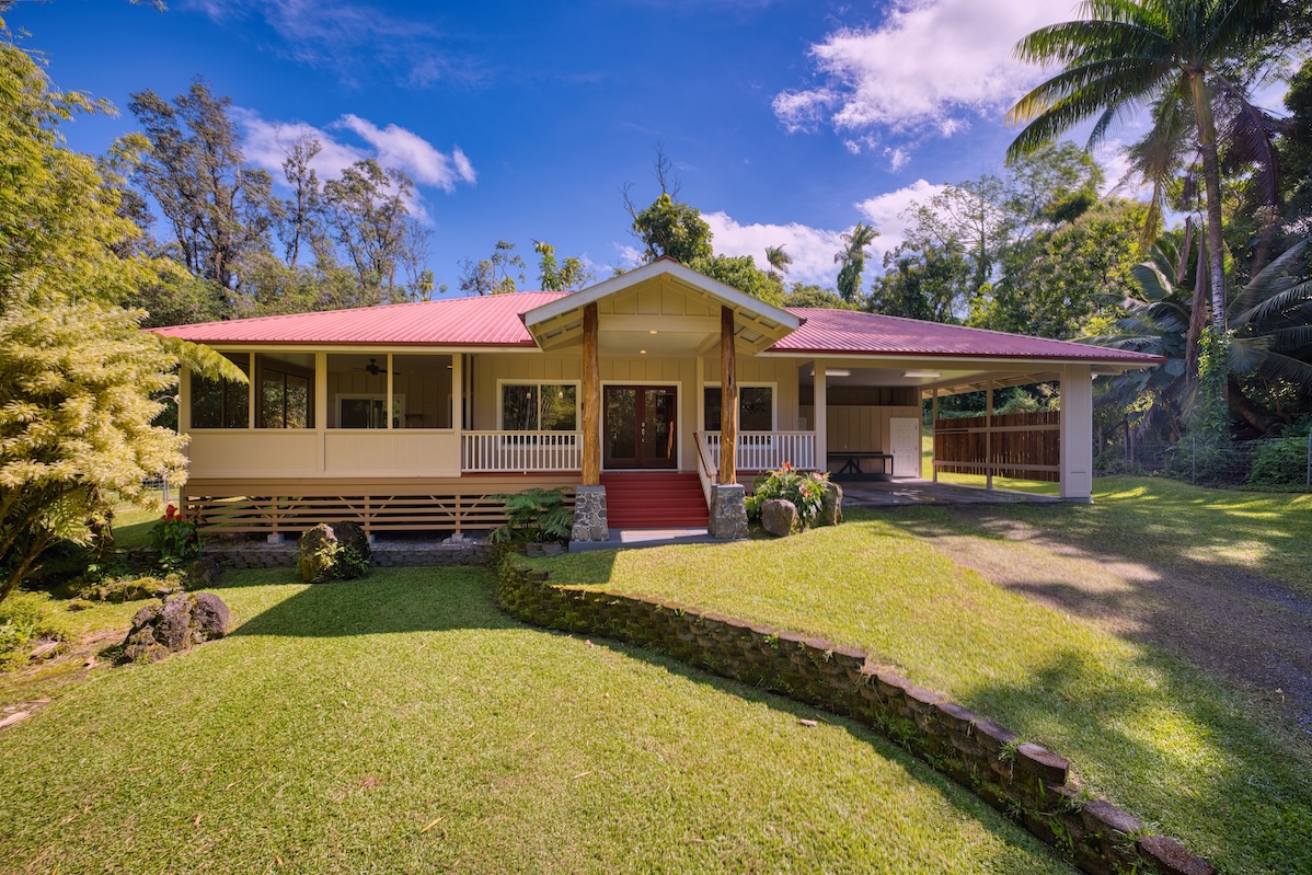 a view of a house with a yard patio and fire pit