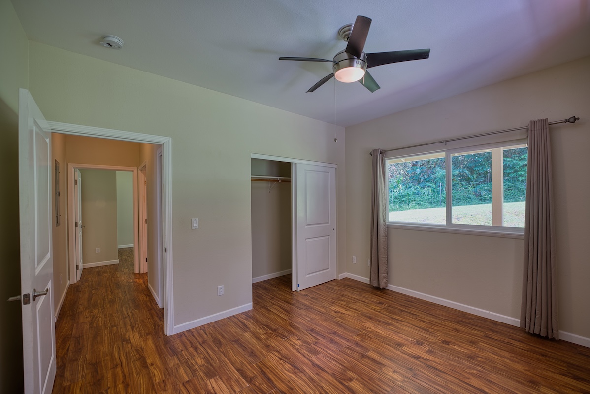 127 Opio Road Hilo, HI 96720 - Photo 12 of 21 a view of empty room with wooden floor and fan