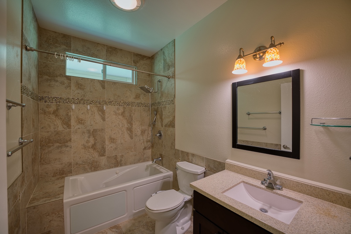 127 Opio Road Hilo, HI 96720 - Photo 5 of 21 a bathroom with a sink toilet vanity and shower
