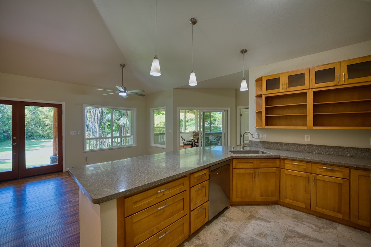 127 Opio Road Hilo, HI 96720 - Photo 6 of 21 a kitchen with a sink window and wooden floor