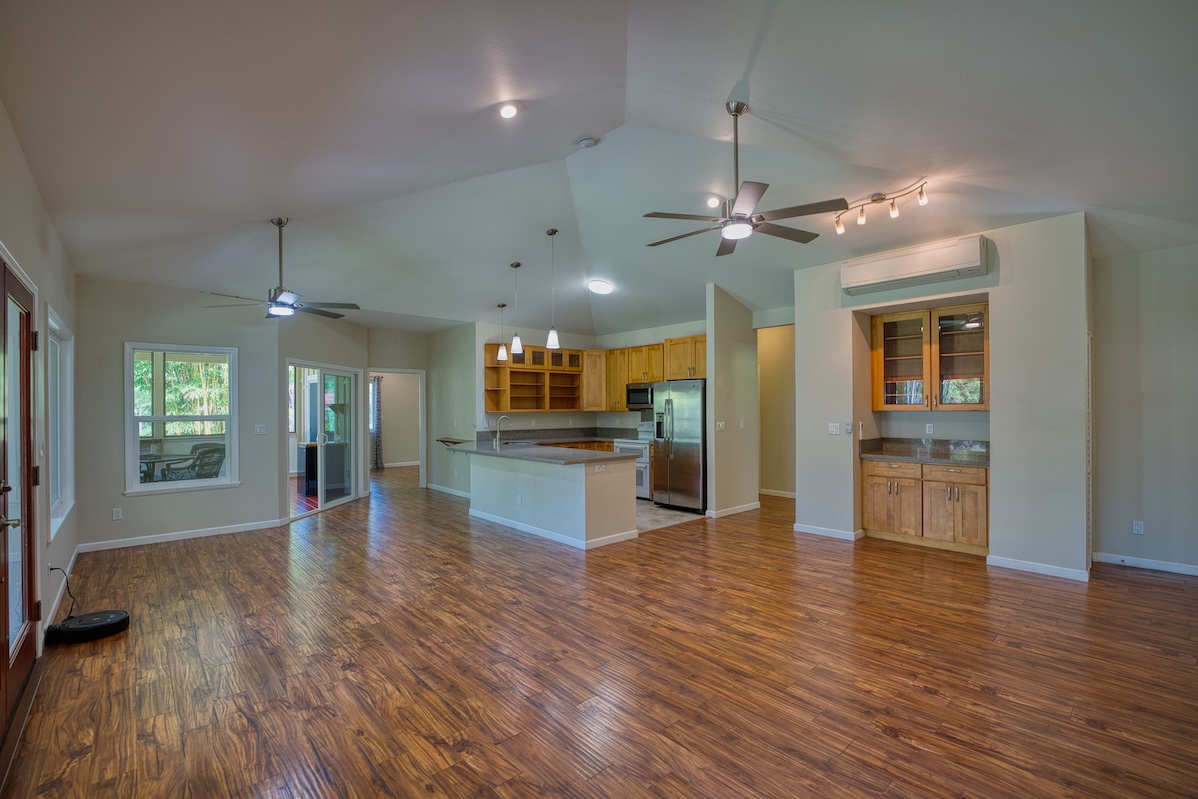 127 Opio Road Hilo, HI 96720 - Photo 9 of 21 a view of a kitchen and an empty room with wooden floor kitchen view
