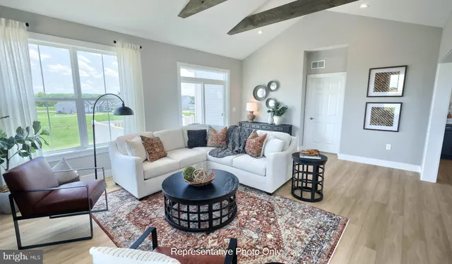 a living room with furniture or couch and a large window