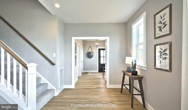 a view of a hallway with furniture and entryway