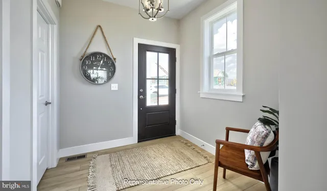 a view of an room with wooden floor and a window