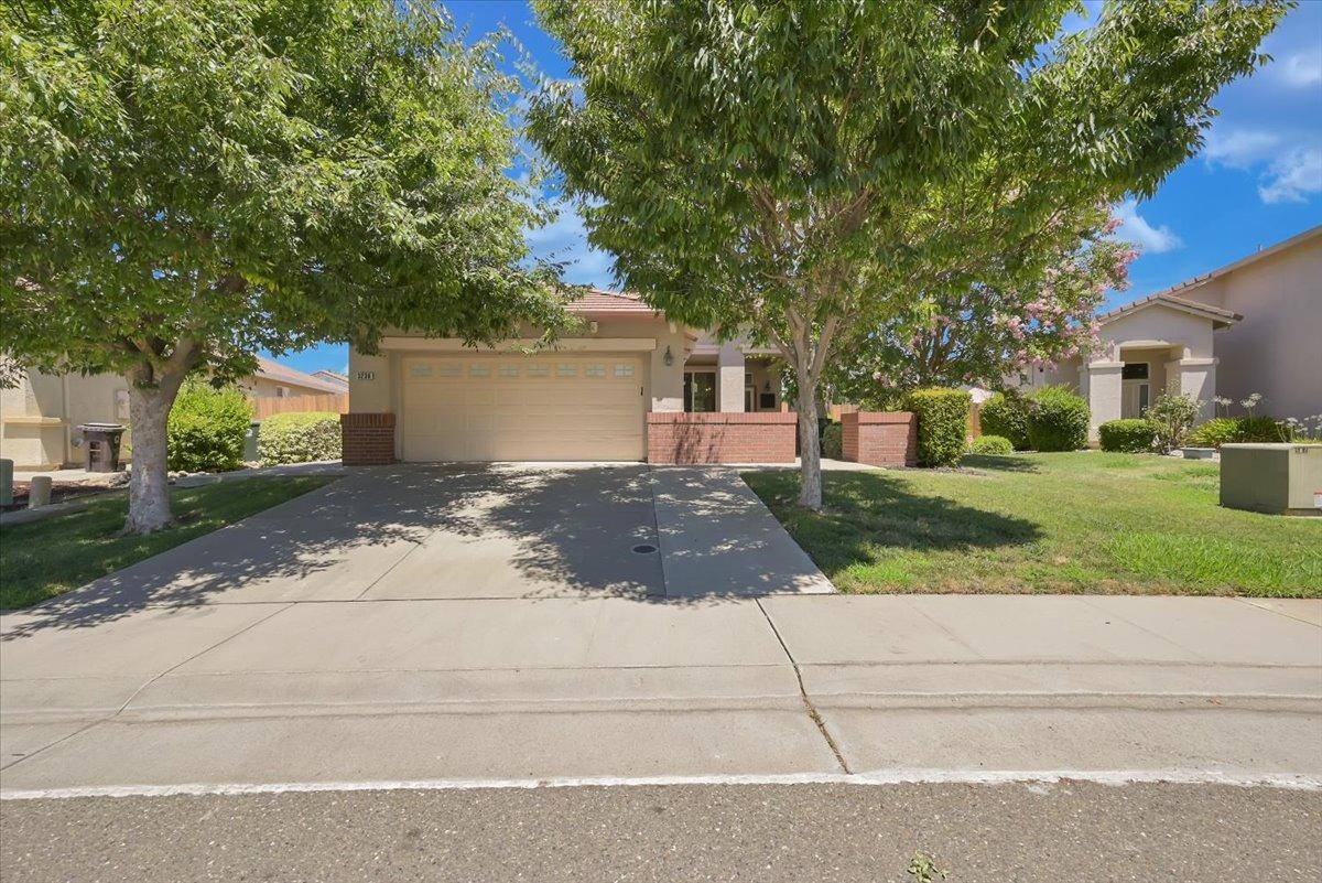 3236 Balada Way Rancho Cordova, CA 95670 - Photo 1 of 1 a front view of a house with a yard and a garage