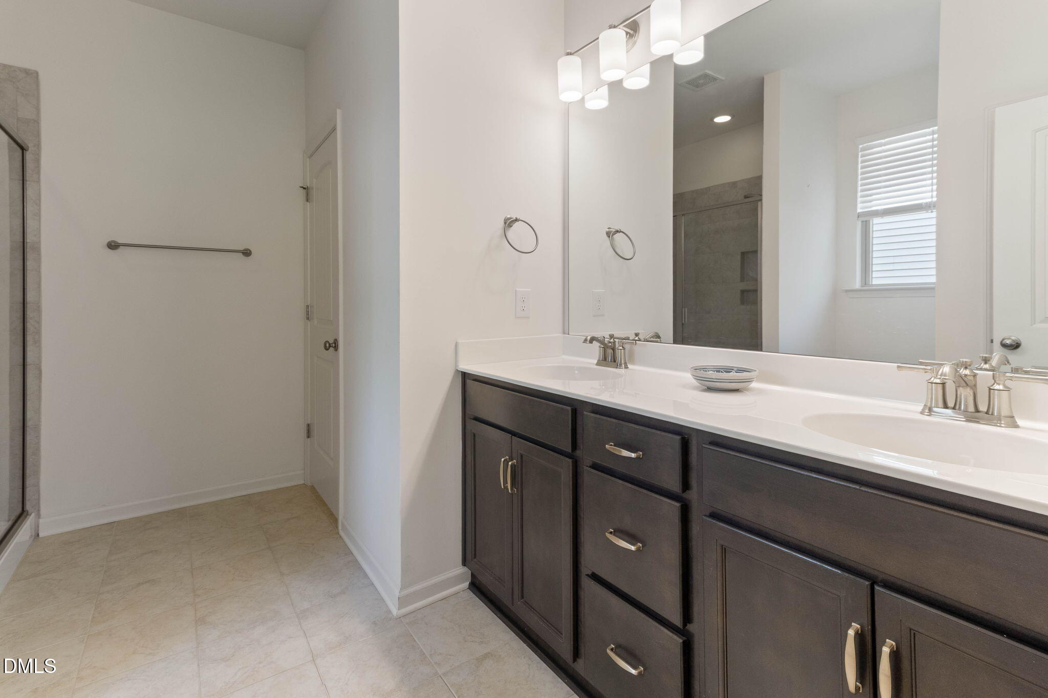 429 Mockingbird Lane Mebane, NC 27302 - Photo 34 of 44 a bathroom with a double vanity sink mirror and shower