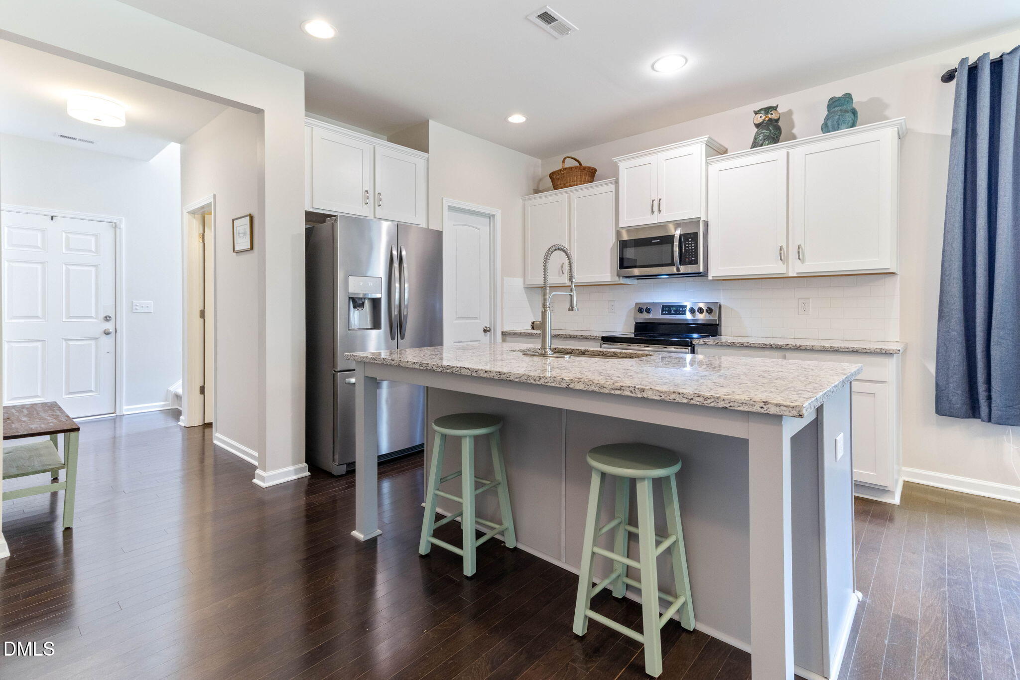 429 Mockingbird Lane Mebane, NC 27302 - Photo 6 of 44 a kitchen with stainless steel appliances granite countertop a refrigerator a sink dishwasher a stove and white cabinets with wooden floor