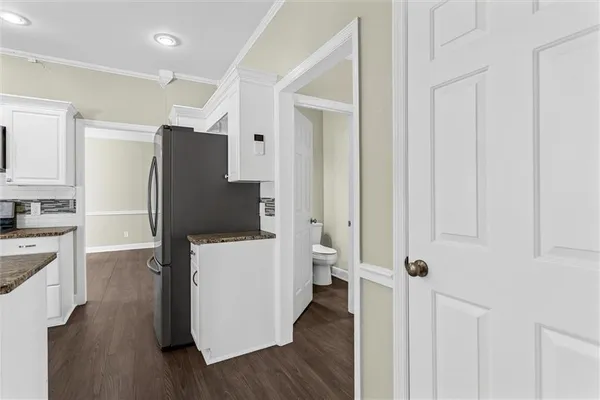an empty room with wooden floor and closet