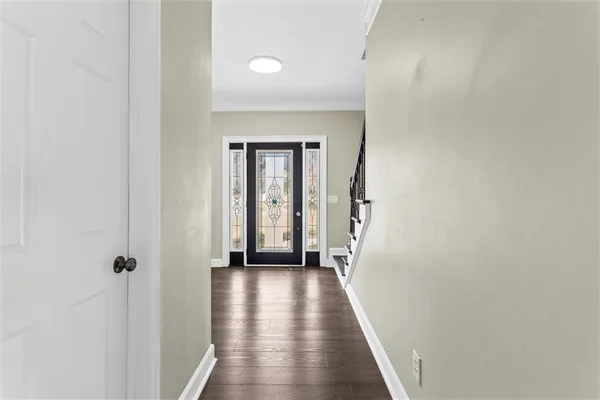 a view of a hallway with wooden floor