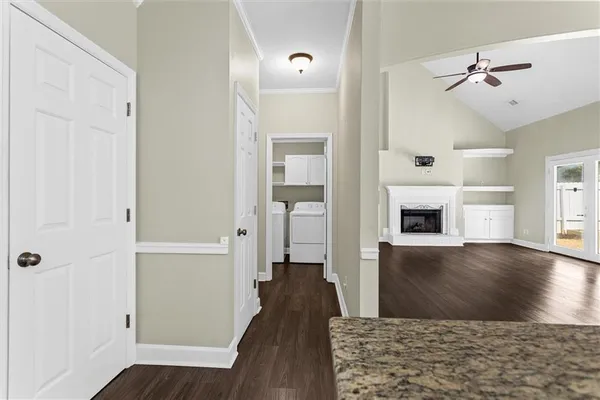 a view of a hallway view with wooden floor and staircase