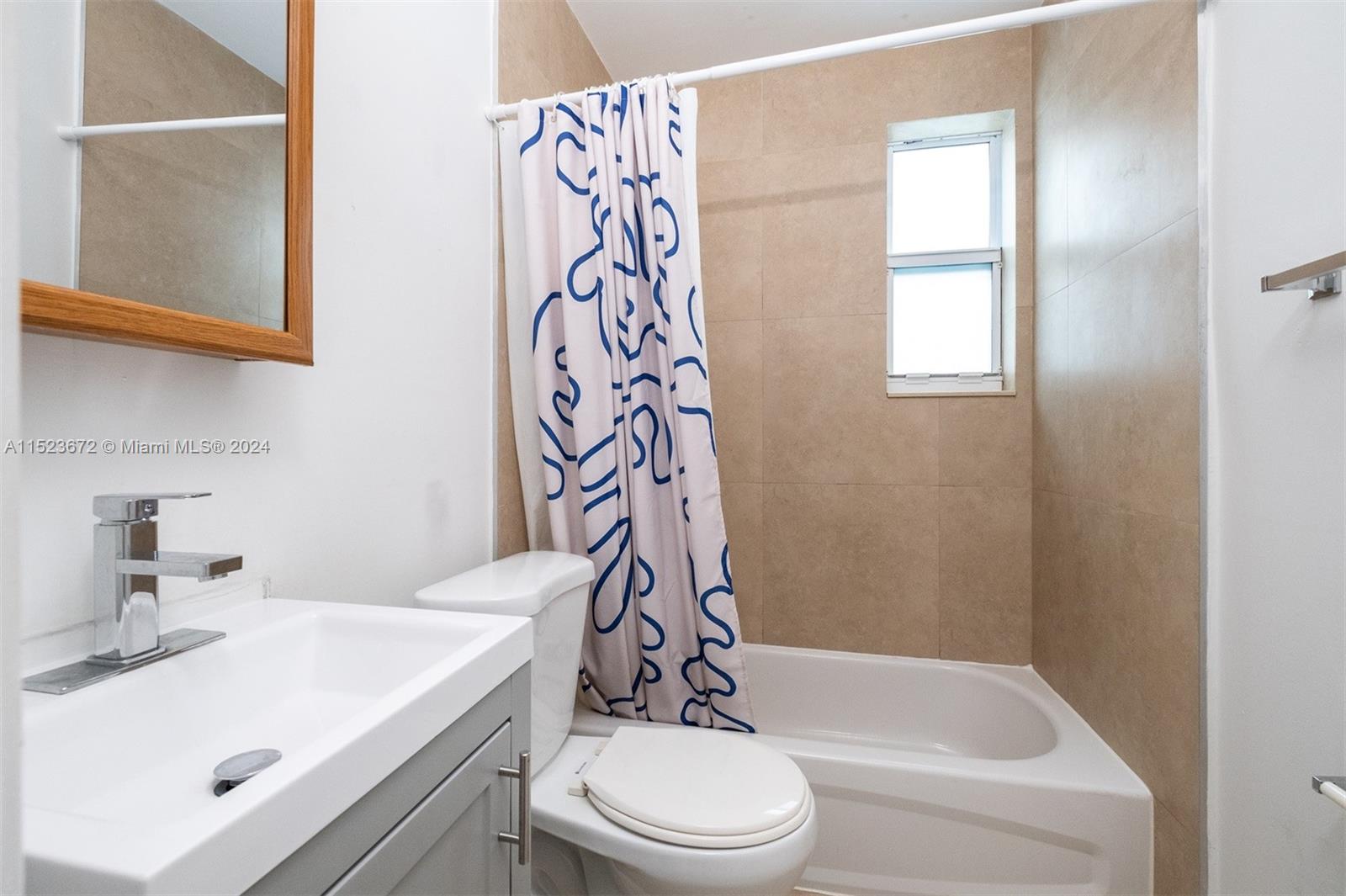 7936 Harding Avenue Miami Beach, FL 33141 - Photo 12 of 18 a bathroom with a sink a toilet and shower
