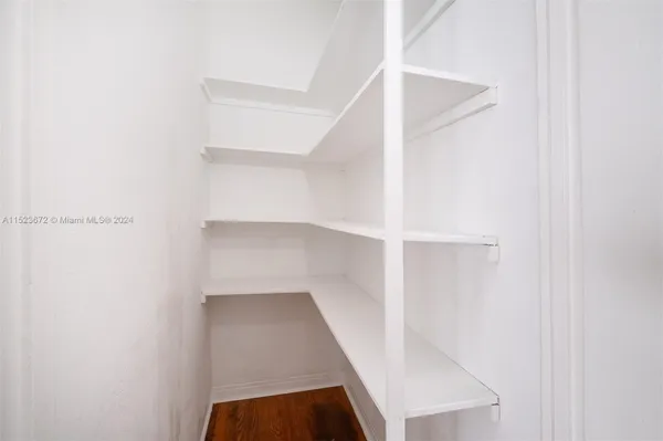 a view of walk in closet with empty racks