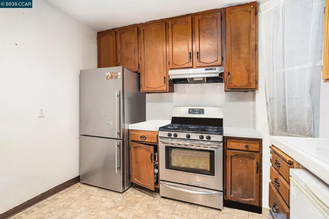 a kitchen with a stove and a refrigerator