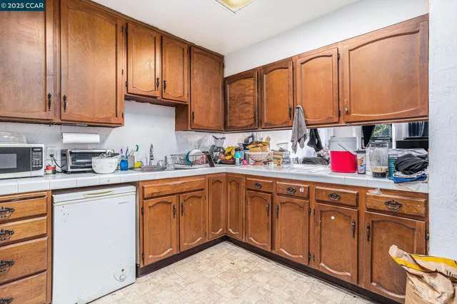 a kitchen with stainless steel appliances granite countertop a sink dishwasher stove and cabinets