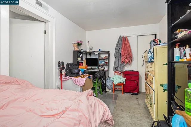 a bed room with a bed and a flat tv screen