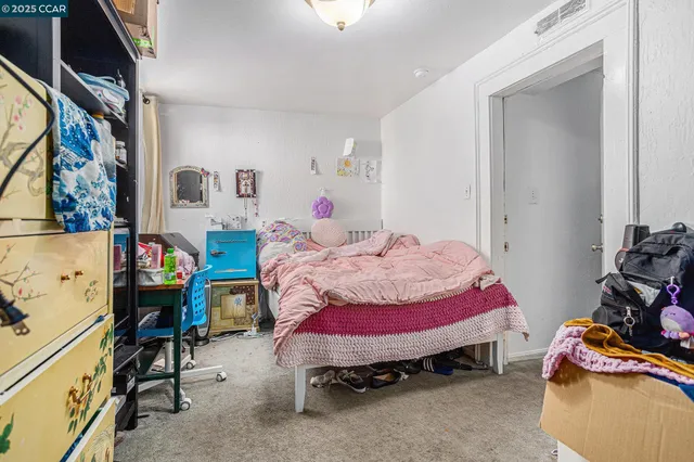 a bedroom with a bed and a closet