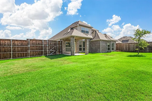 a view of a house with a yard and sitting area