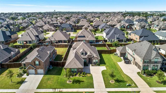 an aerial view of multiple houses with a yard