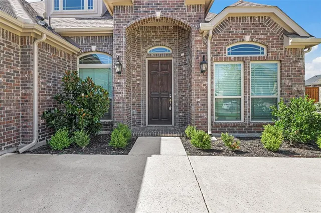 front view of a brick house with a large windows