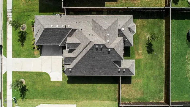 an aerial view of a house with a yard