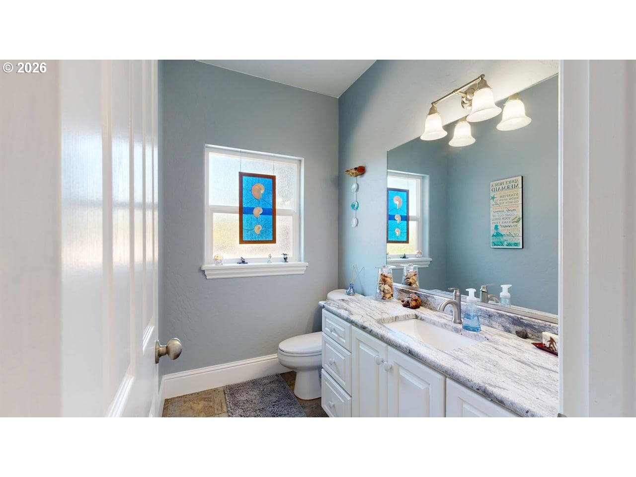 842 Chetco Point Terrace Brookings, OR 97415 - Photo 16 of 33 a bathroom with a sink vanity mirror and toilet