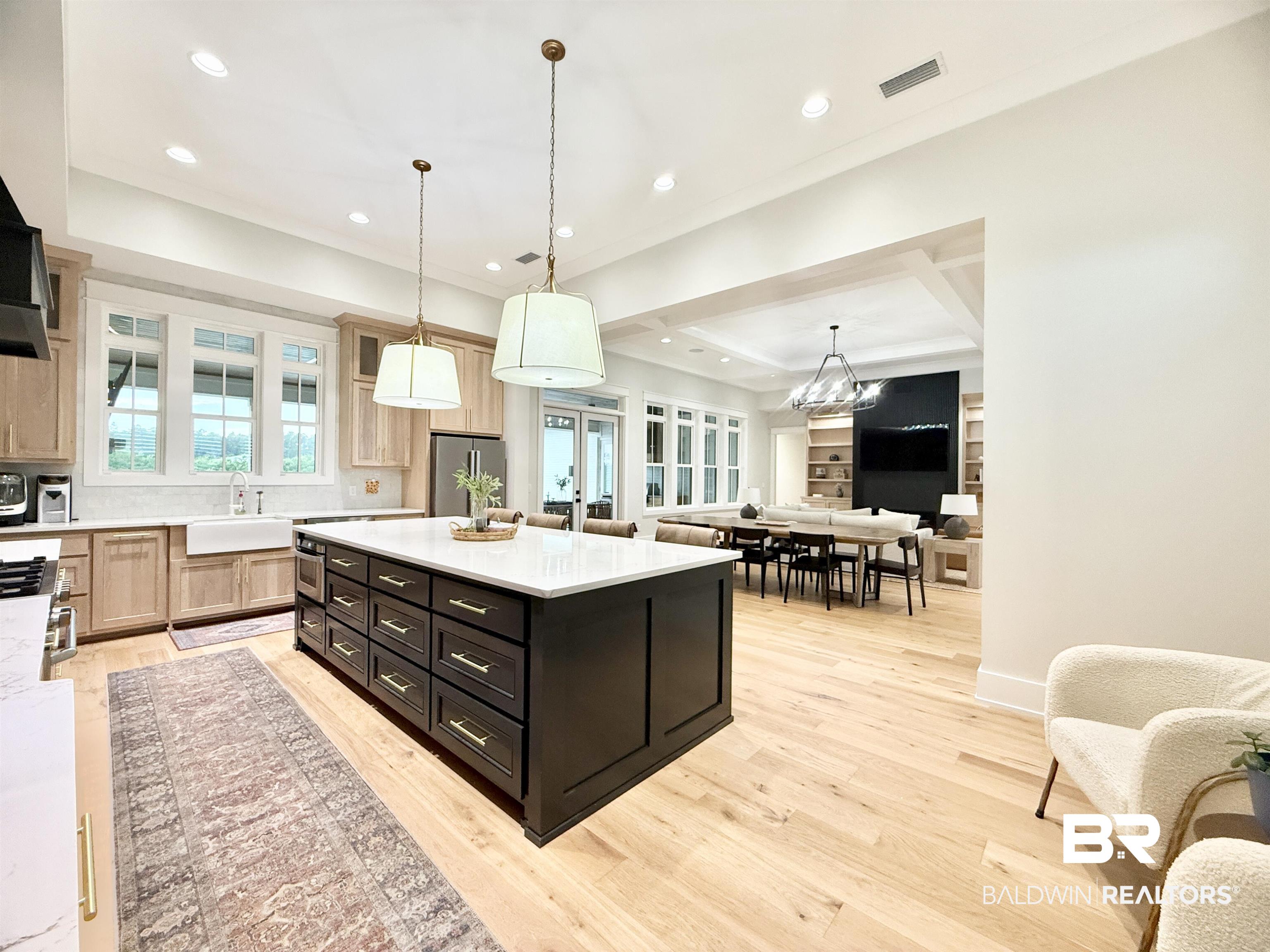 21767 Gallery Boulevard Fairhope, AL 36532 - Photo 73 of 74 Kitchen with light wood finished floors, light countertops, open floor plan, recessed lighting, and a chandelier