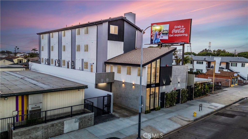 10035 South Western Avenue, Unit 101 Los Angeles, CA 90047 - Photo 20 of 22 a front view of a house with parking area