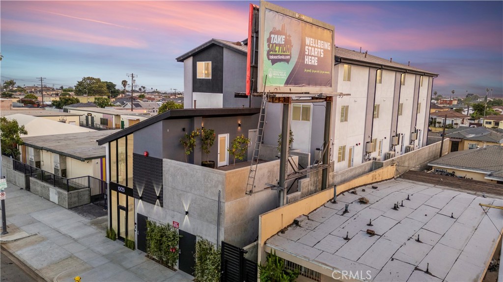 10035 South Western Avenue, Unit 101 Los Angeles, CA 90047 - Photo 21 of 22 a view of a balcony with furniture and wooden floor